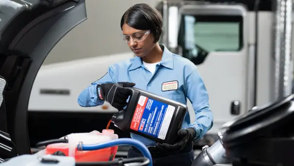 Image of a technician pouring coolant